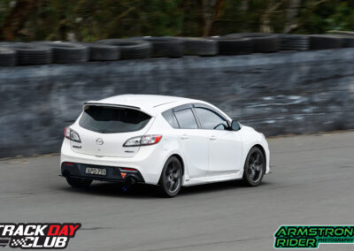 white Mazda on track